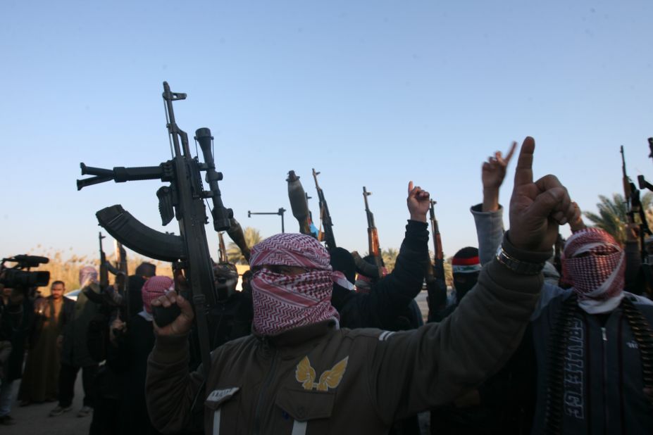 Gunmen protest Iraq's Shiite-led government, demanding that the Iraqi army not try to enter the city of Falluja, on Tuesday, January 7.
