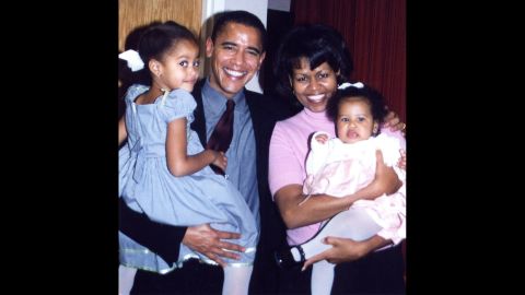 The Obamas are seen with daughters Malia and Sasha at Sasha's christening. Sasha was born on June 7, 2001.