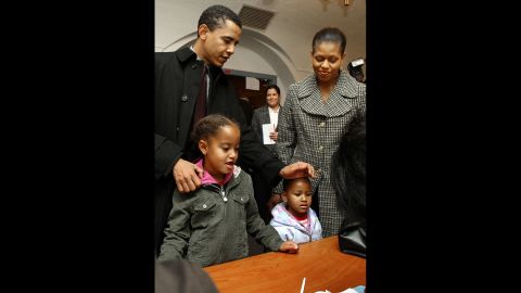 The Obamas check in with poll workers in Chicago in November 2004. Barack Obama would go on to win a US Senate seat.