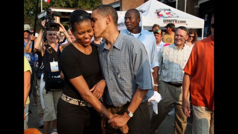 Barack Obama gives his wife a playful kiss as they tour the Iowa State Fair in Des Moines, Iowa, in August 2007. Obama was campaigning at the time for the Democratic presidential nomination.