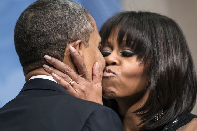 Obama kisses her husband during an inauguration reception at the National Building Museum in Washington in January 2013.