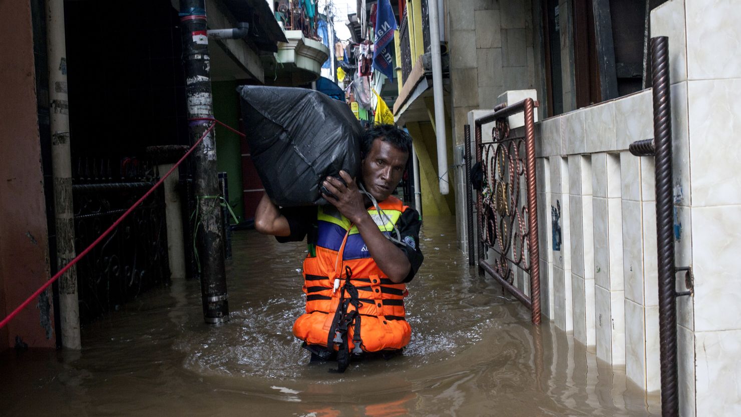 A man brings his belonging through the flooded area on January 13, 2014 in Jakarta, Indonesia. 