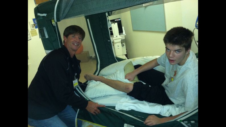 Grant with his father John Virgin. The Virgin family believes fish oil could do for others what it did for their son.