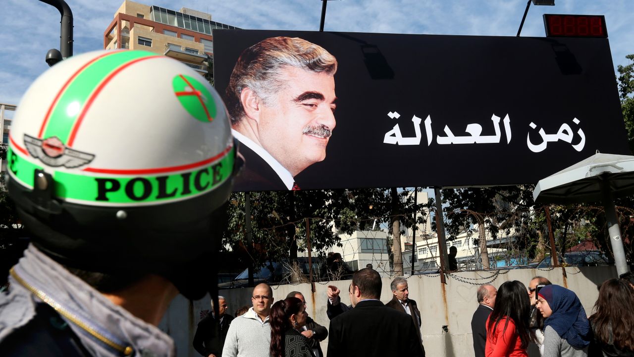 Supporters of slain former Lebanese Prime Minister Rafik Hariri, gather under a giant billboard with his portrait and Arabic that reads, "Justice," a few hundred of meters (yards) from the site of the 2005 blast, in Beirut, Lebanon, Thursday, Jan. 16, 2014.