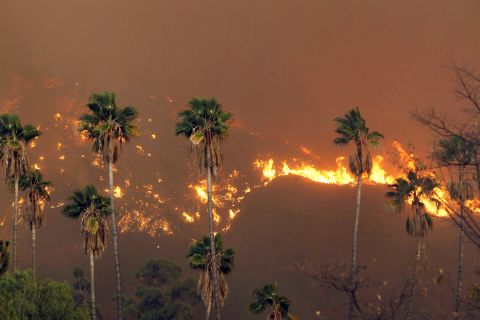 The wildfire burns in the hills just north of Glendora on January 16.