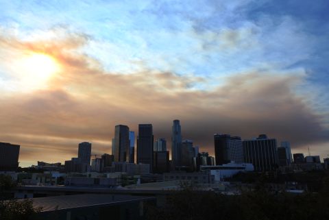 Clouds of smoke from the fire loom over downtown Los Angeles on January 16.