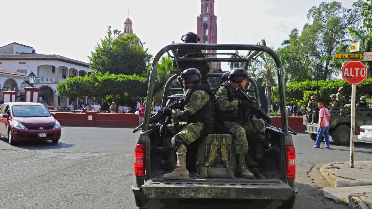 Mexican soldiers patrol the streets of Apatzingan, in Michoacan State, Mexico, on January 16, 2014. On the eve, federal police and army troops said they had 17 cities and towns in western Mexico under control after clashing with vigilantes and seizing Apatzingan (population 120,000) --a bastion of the Knights Templars cartel-- Uruapan (315,000) and Mugica (45,000) among others. The turmoil in Michoacan has become the biggest security challenge for President Enrique Pena Nieto's 13-month-old administration, undermining his pledge to reduce drug violence. AFP PHOTO / ALFREDO ESTRELLA        (Photo credit should read ALFREDO ESTRELLA/AFP/Getty Images)