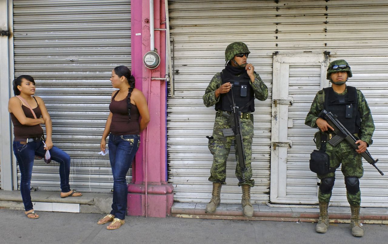 Mexican soldiers patrol the streets of Apatzingan on January 16. The situation with the vigilantes has become a major problem for President Enrique Peña Nieto's government, which has vowed to reduce drug violence.