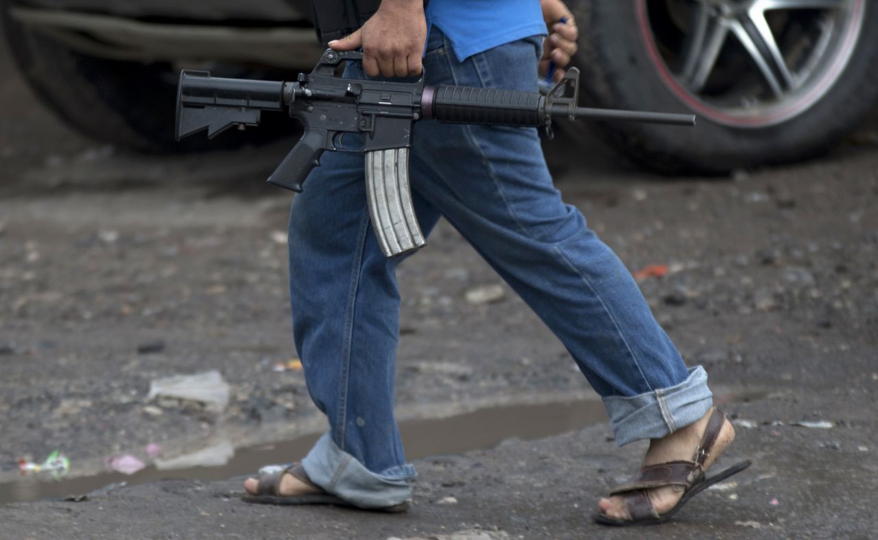 A member of a self-defense group carries a weapon in Antunez, Mexico, on Thursday, January 16. The western state of Michoacan has long been a flashpoint in Mexico's drug war, and such groups have said they were forced to protect violence-torn towns from cartels. The Mexican government has now stepped in, sending federal forces to the region and ordering the vigilante groups to lay down their arms.