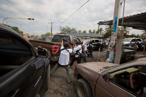 Men from a self-defense group engage in a firefight to flush out alleged members of the Knights Templar drug cartel from Nueva Italia on January 12. Critics suggest the vigilante groups contain some criminals from rival gangs who are using them as a means to win more territory.