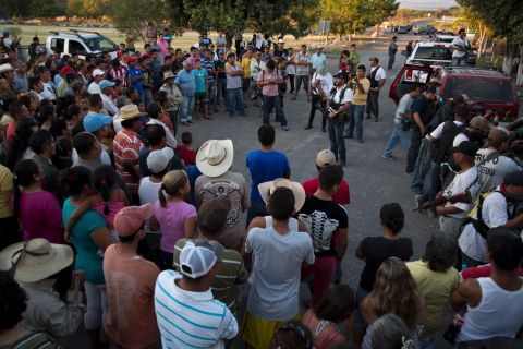 Members of a self-defense group talk to villagers after arriving in Las Yeguas in Michoacan state on Saturday, January 11. Some locals view the vigilantes as heroes, while others see them as villains.