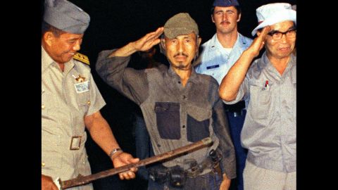 <a href="http://www.cnn.com/2014/01/17/world/asia/japan-philippines-ww2-soldier-dies/index.html">Hiroo Onoda</a>, center, salutes after handing over his military sword on Lubang Island in the Philippines in March 1974. Onoda, a former intelligence officer in the Japanese army, had remained on the island for nearly 30 years, refusing to believe his country had surrendered in World War II. He died at a Tokyo hospital on January 16. He was 91.