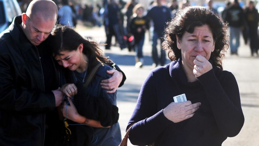 A woman waits at a staging ground area where families are being reunited with Berrendo Middle School students after a shooting at the school, Tuesday, Jan. 14, 2014, in Roswell, N.M. A shooter opened fire at the middle school, injuring at least two students before being taken into custody. Roswell police said the school was placed on lockdown, and the suspected shooter was arrested. (AP Photo/Roswell Daily Record, Mark Wilson)