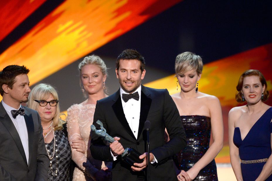 Bradley Cooper and the cast of "American Hustle" accept the award for outstanding performance by a cast in a motion picture. Cooper, practically yelling his approval, paid tribute to director David O. Russell for the film.