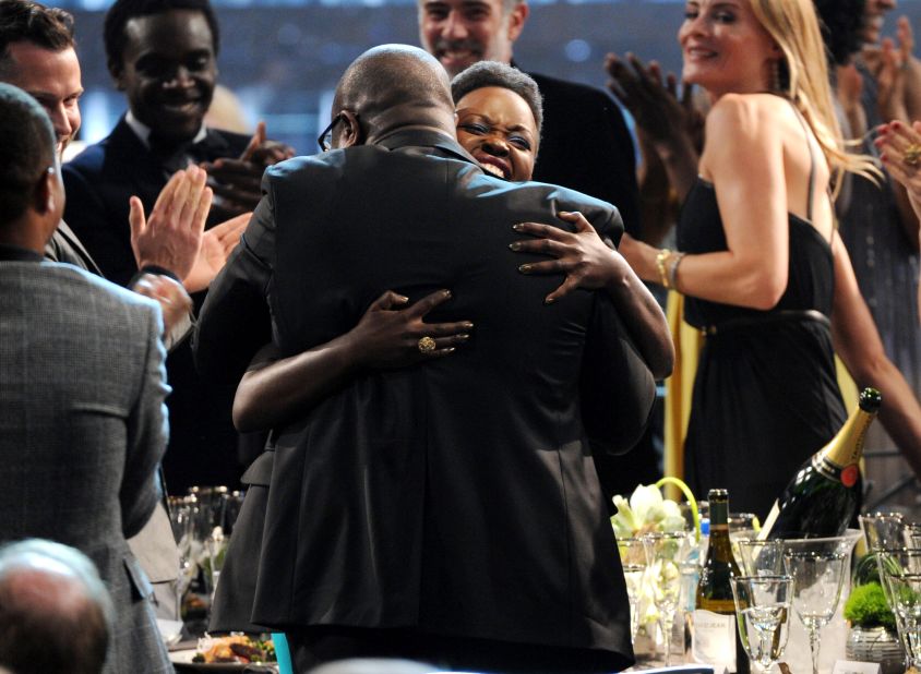 Nyong'o embraces director Steve McQueen after winning her award.