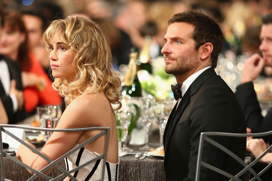 Model Suki Waterhouse and Bradley Cooper sit in the audience.