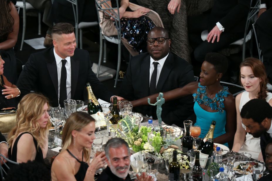 From left, Brad Pitt, Steve McQueen and Lupita Nyong'o at their table during the show.