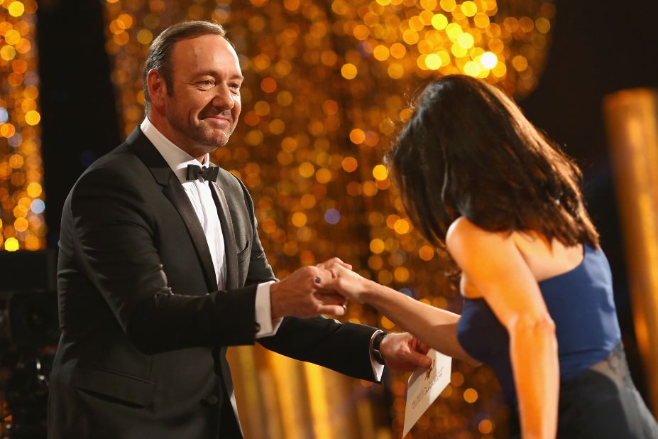 Kevin Spacey helps Julia Louis-Dreyfus onstage. She won best female actor in a comedy series for "Veep."