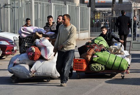 Syrian refugees enter Turkey via the Cilvegozu border gate in Hatay, Turkey, on Saturday, January 18.