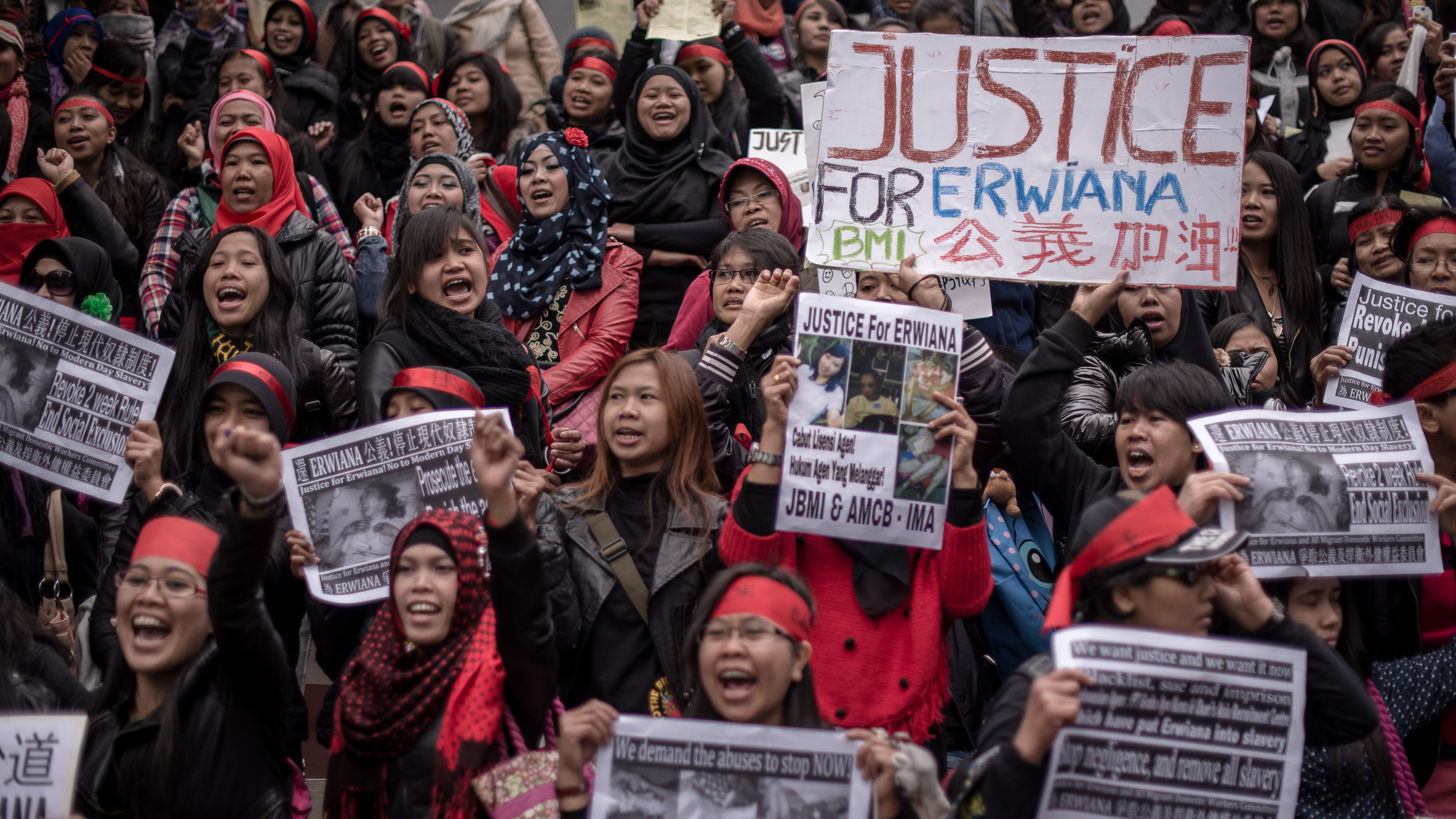 Protesters march in support of an Indonesian worker allegedly tortured by her employer in Hong Kong on January 19, 2014. 