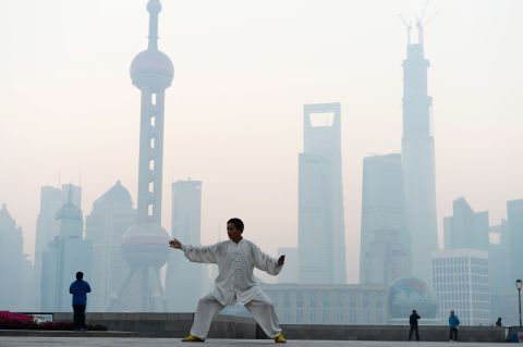 A man practices Tai Chi in Shanghai as heavy smog engulfs the city on November 7, 2013. In 2010, 40% of the world's premature deaths caused by air pollution were in China, according to a survey <a href="http://www.thelancet.com/journals/lancet/article/PIIS0140-6736%2813%2962693-8/fulltext?rss=yes" target="_blank" target="_blank">published in the Lancet. </a>