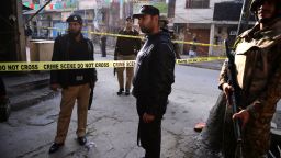 Pakistani soldiers and policement block off the site of suicide bomb attack in Rawalpindi on January 20.