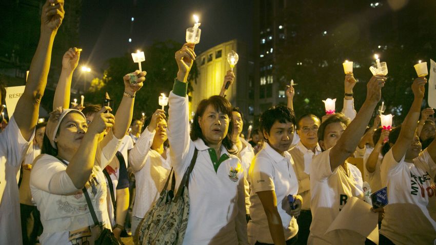 Protesters calling for elections and democracy hold candles during a pro-election campaign January 19, 2014 in Bangkok.