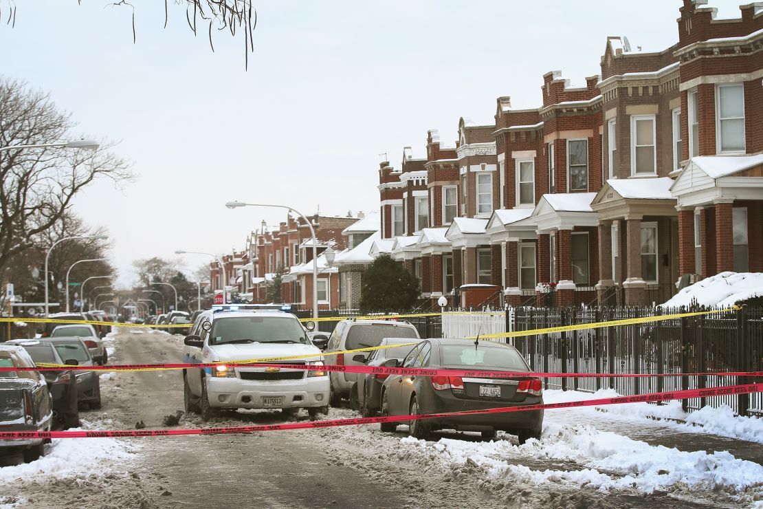 Police investigate a murder of a 68-year-old man in the Logan Square neighborhood of Chicago on December 15, 2013.