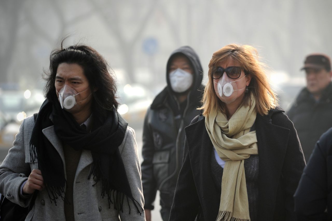 People use face masks during their commute in Beijing on January 16. The Chinese government is trying to control the number of new vehicle registrations this year in some cities to help improve air quality, <a href="http://money.cnn.com/2014/01/20/autos/china-autos-pollution/">CNNMoney reports</a>.