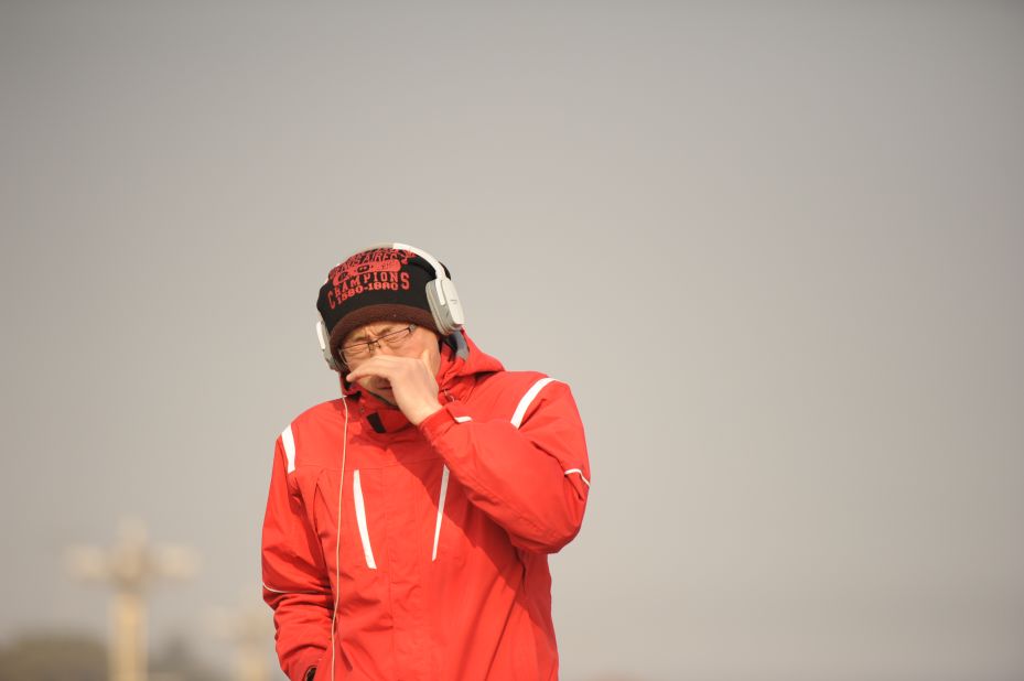 A pedestrian covers his mouth and nose in Beijing's Tiananmen Square on January 16.