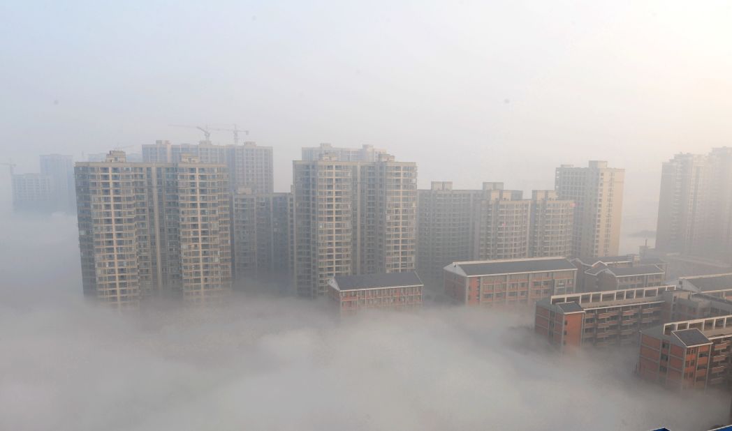 Smog shrouds buildings in Changsha in Hunan province on January 14.
