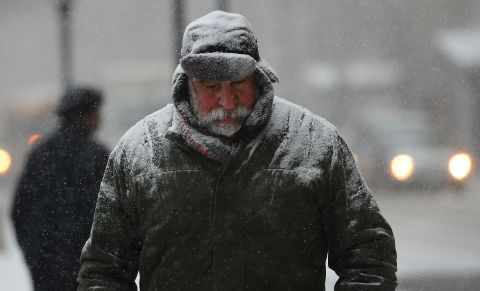 A man walks through a snow storm in New York on January 21, as a storm alert was issued from noon Tuesday until 6 a.m. Wednesday, with as much as a foot of snow forecast for the metro area.