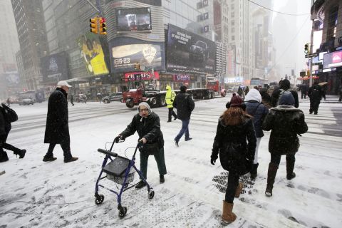 Pedestrians make their way through snowfall in New York's Times Square on January 21.