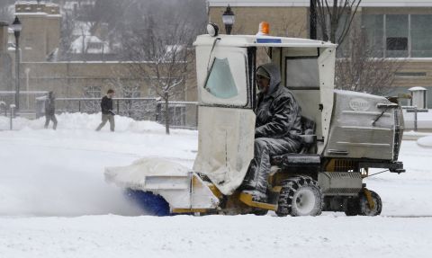 A worker clears snow off sidewalks at Xavier University in Cincinnati, Ohio, on January 21.