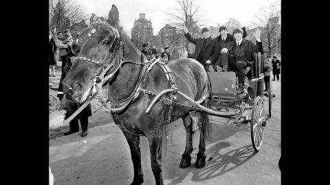 Ringo Starr, Paul McCartney and John Lennon wave from a hansom cab in Central Park the day after the Beatles' arrival in the United States for the first time. George Harrison was off nursing a sore throat. 