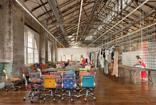 The derelict warehouses that comprise Urban Outfitters corporate campus dovetail nicely with the brand's kooky fashion sense. Indoor walkways are lined with ponds and flowers to offset the industrial feel, and brightly-patterned chairs pop amid the gritty surroundings.