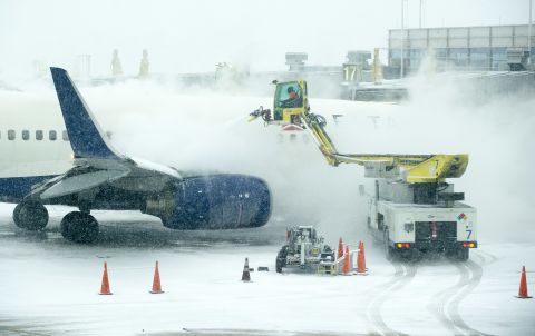  An airplane is de-iced as heavy snow falls at Ronald Reagan National Airport in Arlington, Virginia, on January 21.