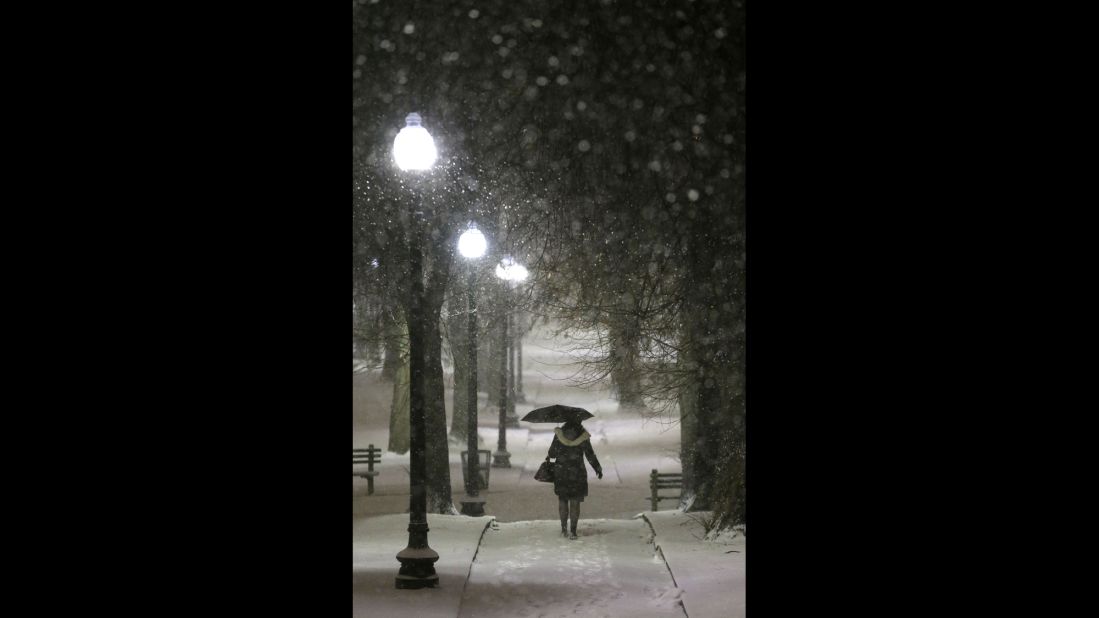An umbrella comes in handy for a woman on a snow-covered path in Boston Common on January 21.
