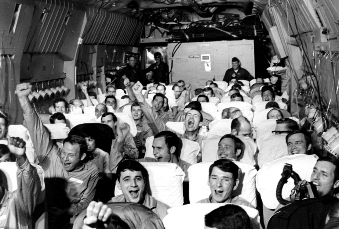American ex-POWs celebrate leaving North Vietnam in 1973 aboard a C-141 Starlifter dubbed the Hanoi Taxi.