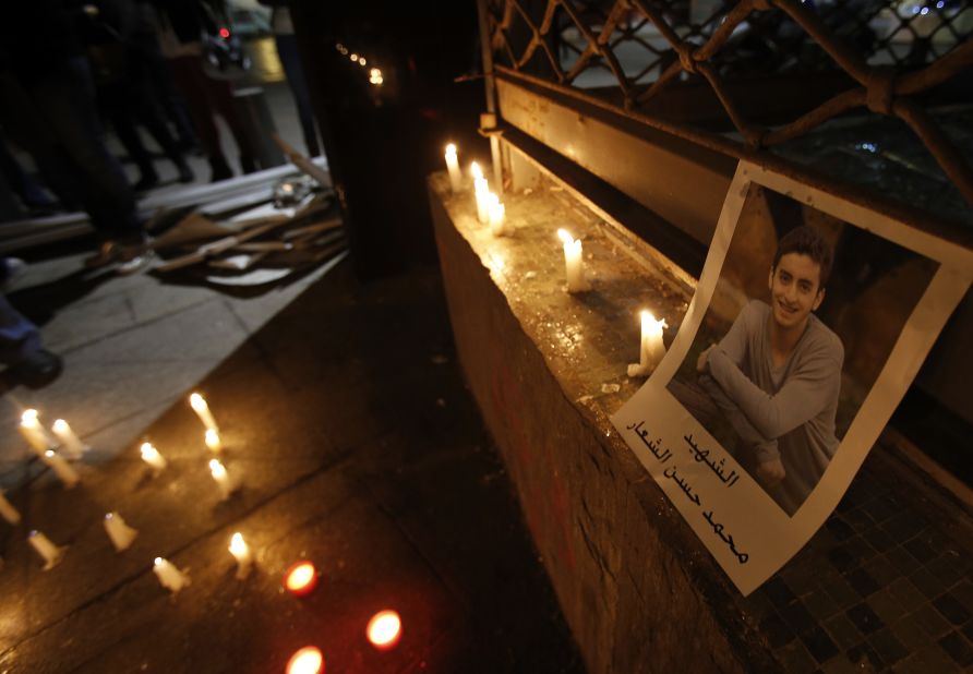 A portrait of Mohammad al-Chaar is seen during a candlelight vigil at the site of the blast. The car bombs haven't stopped since his death.