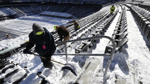Workers shovel snow off seating at MetLife Stadium in East Rutherford, New Jersey, on January 22. The stadium will host Super Bowl XLVIII.