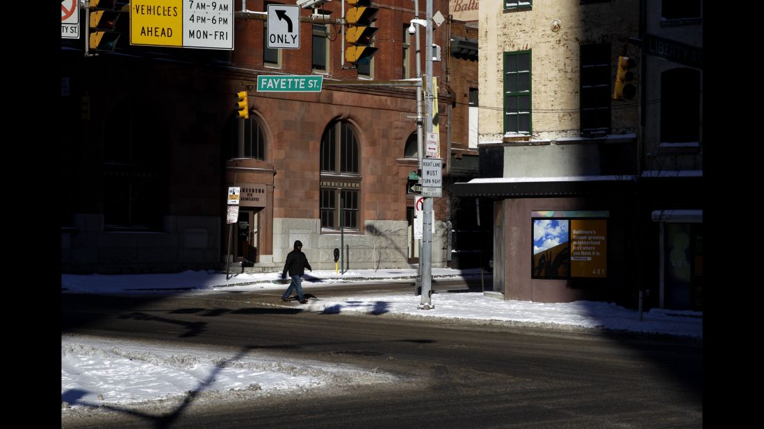 A man crosses a street in downtown Baltimore on January 22.