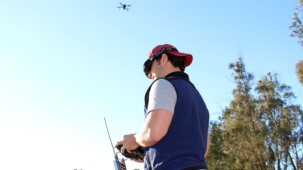 <a href="http://3drobotics.com/" target="_blank" target="_blank">3D Robotics</a> employee Pablo Lema views live video streamed from the drone above his head. The first-person view is displayed on his goggles, while he steers the device with a hand-held controller.