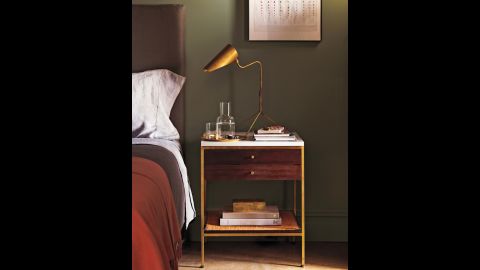 Brass works well with so many furniture periods. Here, a vintage gilt edged Paul McCobb end table is paired with a contemporary brass lamp. 