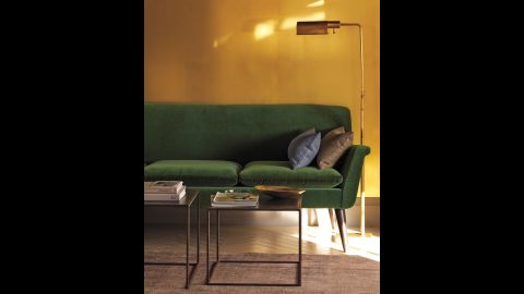 Go bold. A wall clad in sheets of unlacquered, untreated brass laminate adds high drama to a living room. A complement to the forest green sofa and brass accents in this room, the partition will develop a rich patina over time. To achieve a similar effect on a smaller scale, try applying the sheeting to the back of a bookshelf or wet bar. 