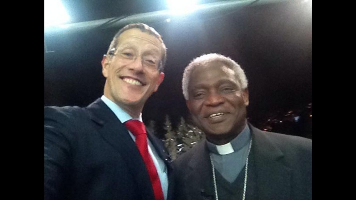 Richard Quest manages to snap a selfie with cardinal Turkson, as he brought a message from Pope to Davos.