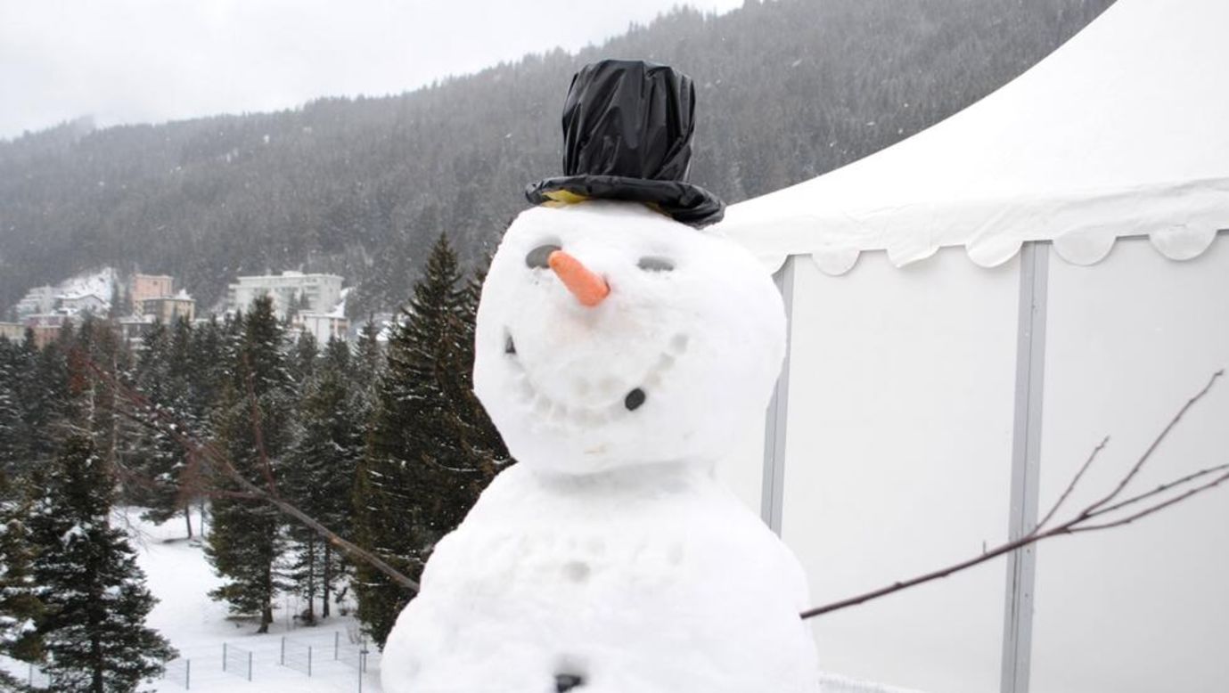 The traditional World Economic Forum snowman stands guard outside CNN's live position.