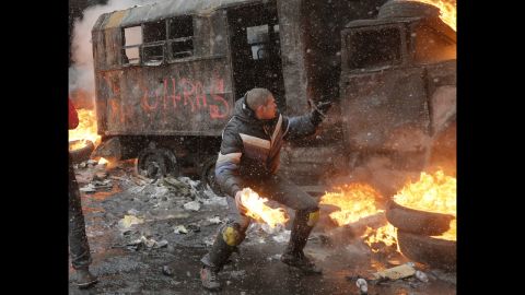 A protester throws a Molotov cocktail during clashes with police in central Kiev.