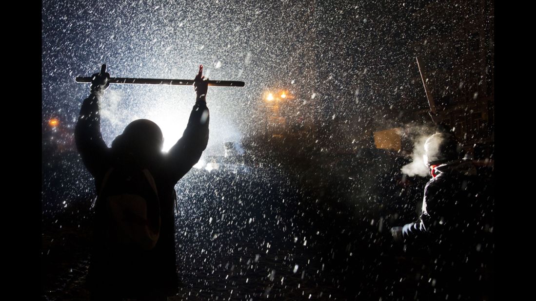 Protesters clash with police in Kiev as snow falls on January 22.
