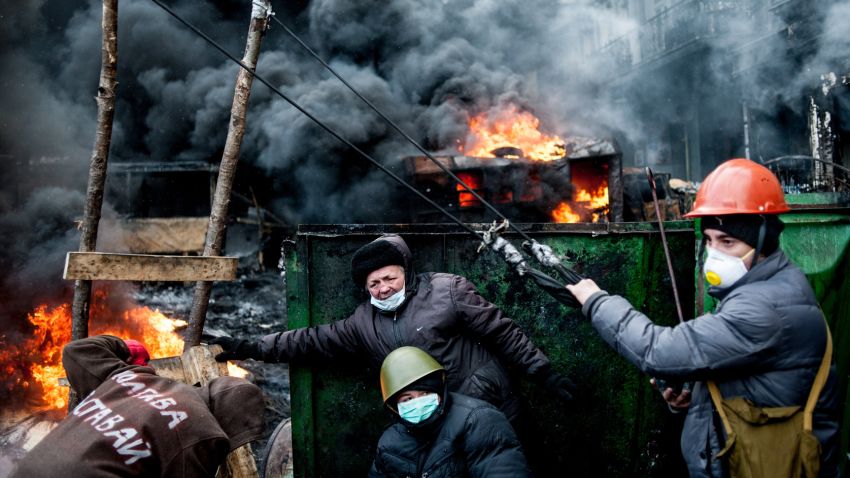 Ukrainian protesters use a huge catapult to throw stones at riot police as tires burn in Kiev on Thursday, January 23.
